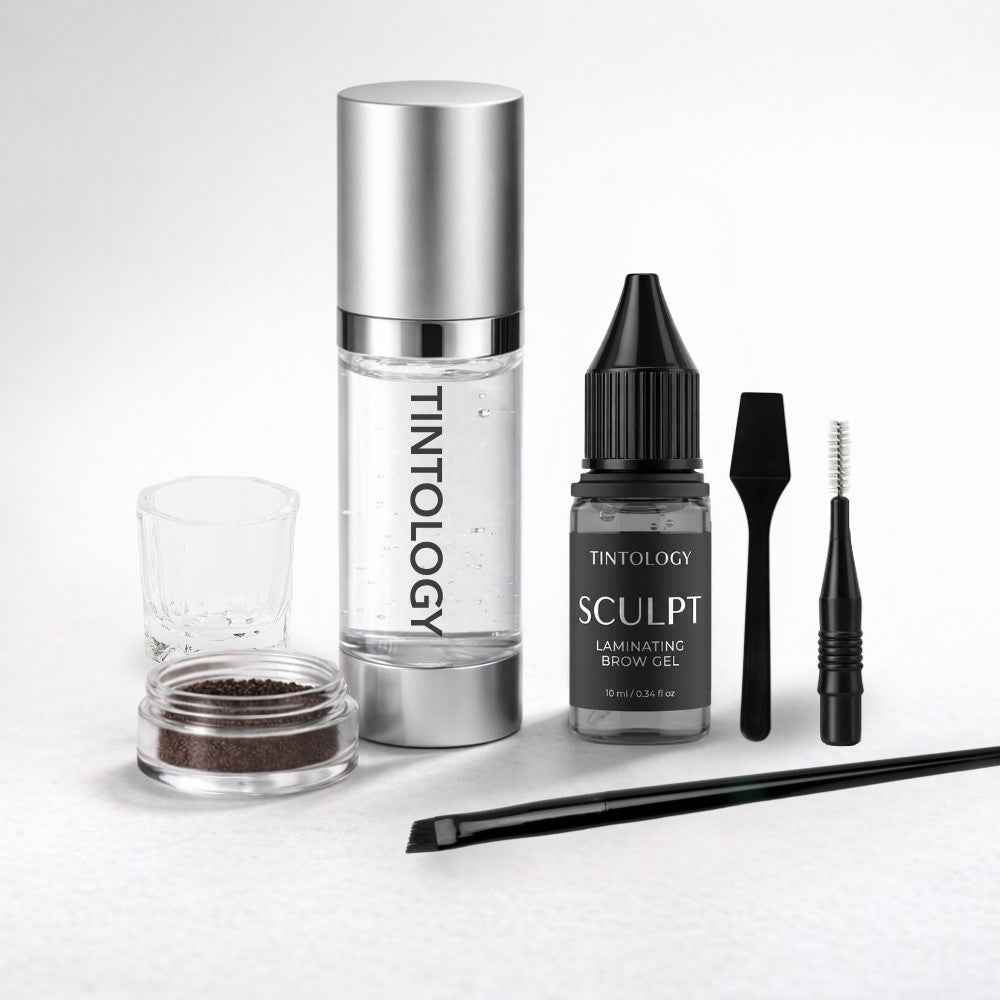 Tintology lami and tint kit products including a bottle, applicator, and other tools on a white background.