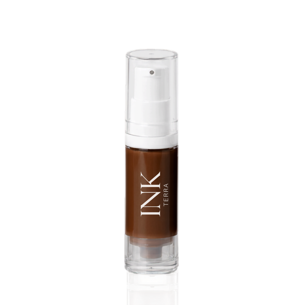 INK liquid-to-powder brow pigment in shade TERRA, clear airless pump bottle on a white background