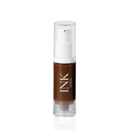 INK liquid-to-powder brow pigment in shade TERRA, clear airless pump bottle on a white background
